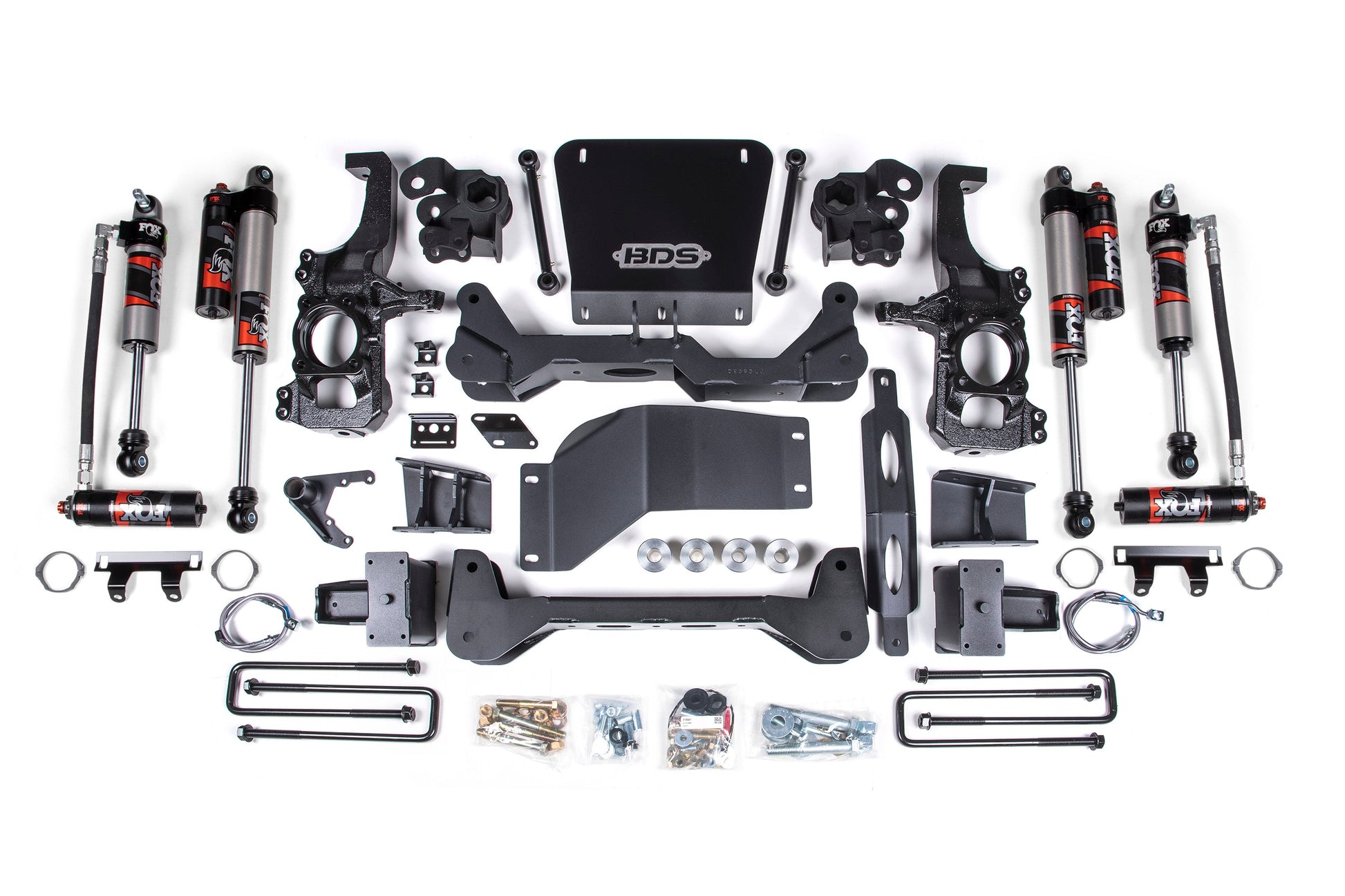 The 6.5 Inch Lift Kit | FOX Performance Elite by BDS includes various components such as shock absorbers, control arms, brackets, bolts, and other necessary hardware. The kit's parts are neatly arranged on a white background with a central plate featuring the "BDS" logo. This product is ideal for installing your 2020-2024 Chevy Silverado or GMC Sierra 2500HD/3500HD (20-24) 4WD lift kit.