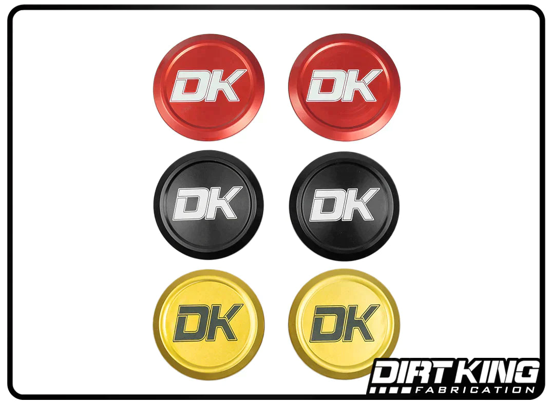 A grid of six 07-18 GM 1500 Ball Joint Caps, crafted from 6061 aluminum and engraved with "DK", is displayed. These DIRT KING caps come in three colors: two red with an anodized finish, two black, and two yellow. In the bottom right corner, the logo "DIRT KING Fabrication" is featured.