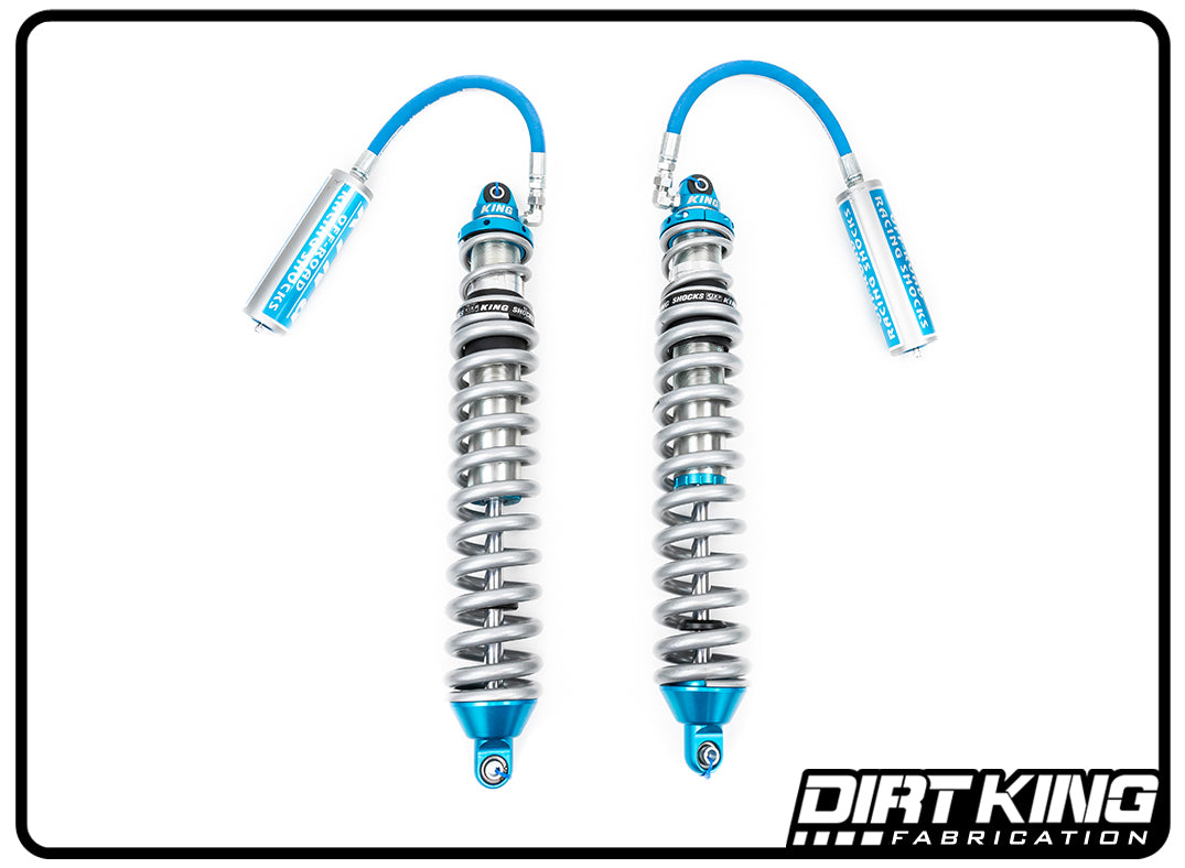 A pair of blue and silver Dirt King 99-18 GM 1500 Long Travel Race Kit Spec King Coilovers with remote reservoirs, branded with DIRT KING SHOCKS logos, are placed side by side against a white background. These coilover shocks are designed for superior off-road performance in vehicle suspension systems.