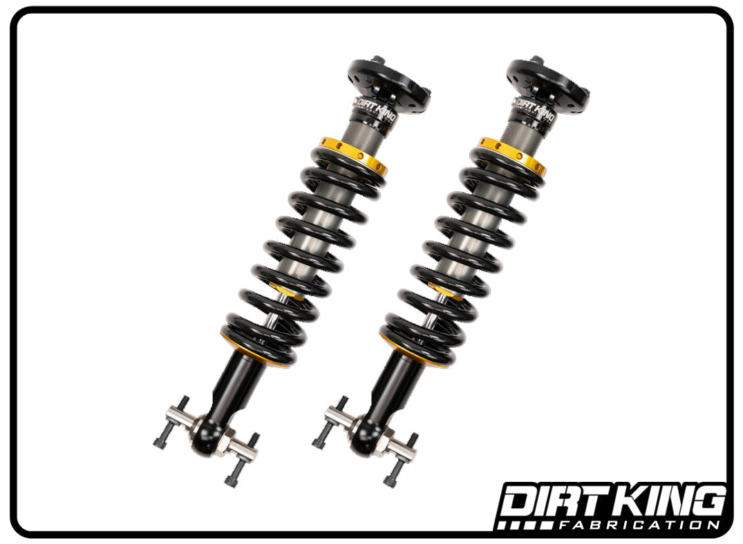 This image features a pair of black and yellow Dirt King 19-23 GM 1500 2.0 IFP Coilovers from DIRT KING SHOCKS, displayed against a white background. Each coilover includes a coiled spring and mounting components, with the brand's logo on the bottom right corner, showcasing their proficiency in GM 1500 coilovers.