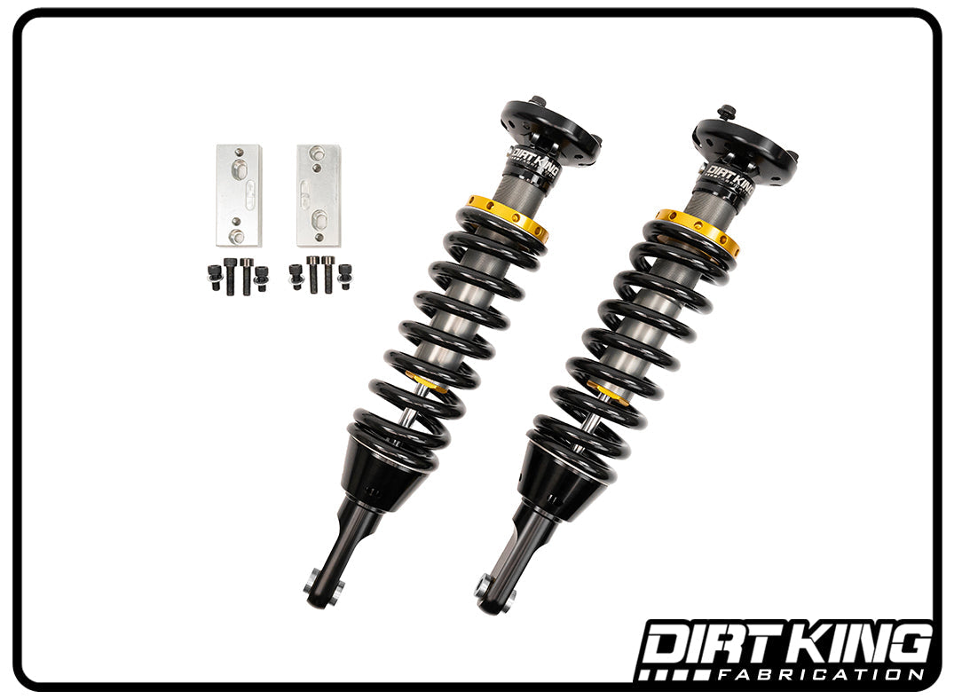 A pair of Dirt King 05-23 Toyota Tacoma 2.0 IFP Coilovers in black and gold from DIRT KING SHOCKS are showcased on a white background. Complete with mounting brackets and small hardware components, these high-performance coilovers are designed to enhance your ride with precision and style.