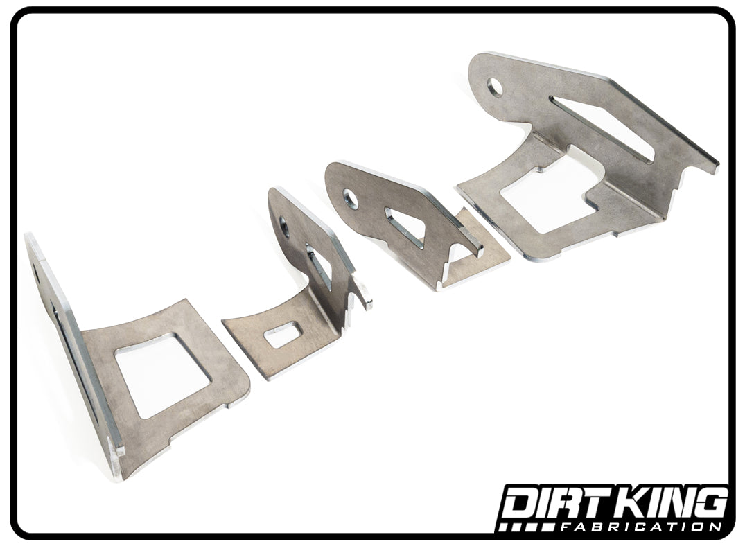 Three metal fabrication parts with various cutouts are displayed against a white background. The parts have an industrial design with asymmetrical shapes and sharp edges, showcasing precision manufacturing. A coil bucket is among the items featured. The text "DIRT KING" is in the bottom right corner, highlighting the 07-21 Toyota Tundra Upper Arm Double Shear Kit.