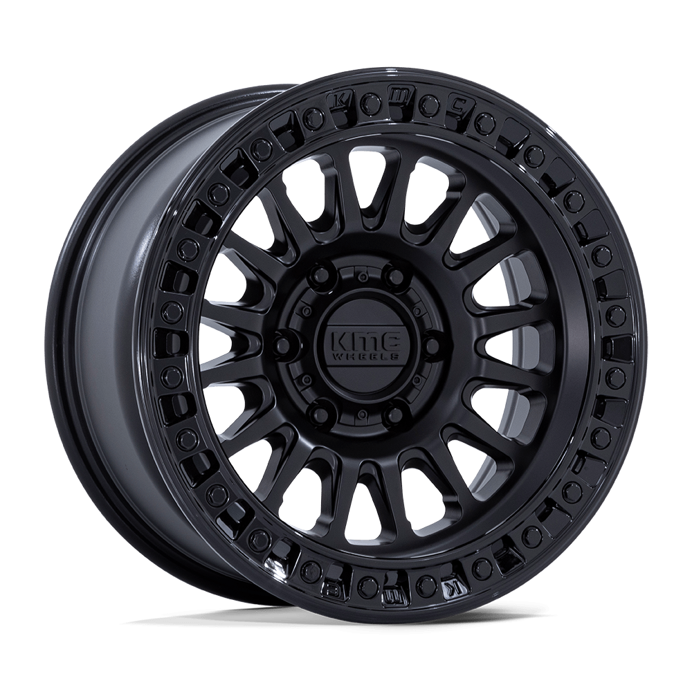 A black alloy wheel featuring a multi-spoke design and a central hub labeled with "KMC." The rim showcases an immaculate, glossy finish with bolt holes around the edge, enhanced by the distinctive KM552 IMS Matte Black with Gloss Black Lip.