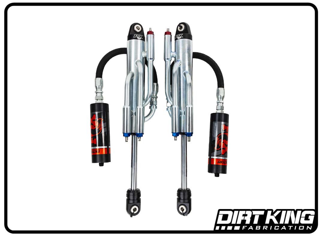 A set of Dirt King Ford F-150 Long Travel Spec Fox Triple Bypasses from DIRT KING SHOCKS are displayed inside a black border. The shocks feature silver bodies with black, red, and blue accents, incorporating advanced suspension dampening technology. The DIRT KING SHOCKS logo is prominently placed in the bottom right corner.