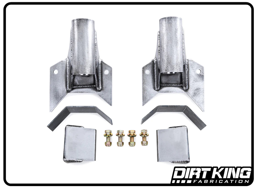 The 05-23 Toyota Tacoma Leaf Under Bump Stop Mount, designed by DIRT KING, is an ideal set of metal fabrication parts for suspension dampening. It includes two large brackets, two rectangular blocks, angled pieces, and four bolts with nuts. The components are arranged on a white background with "DIRT KING" printed in the bottom-right corner.