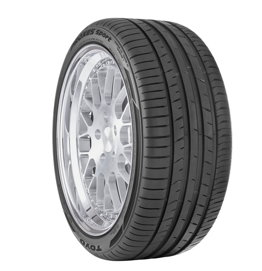 A close-up of a TOYO Proxes Sport Tire 225/45ZR17 94Y showcases its tread pattern and reflective alloy wheel. The brand and model, "TOYO Proxes Sport," are prominently visible on the sidewall as it stands against a plain white background.