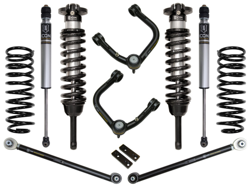 Photograph of the ICON 2010+ Toyota FJ/4Runner 0-3.5in Stage 3 Suspension System w/Tubular UCA by ICON, featuring two coilover shocks, two coil springs, and corrosion-resistant upper control arms with Delta Joints. Various linkage rods and components are meticulously displayed on a white background.