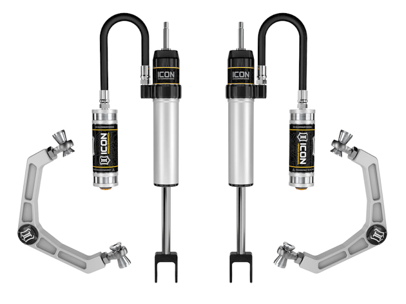 Showcased are two sets of automotive suspension components and shock absorbers: the ICON 2020+ GM HD 0-2in RR Shock System features black fittings labeled "ICON Vehicle Specific," while nearby sit silver upper control arms with adjustable alignment joints from the same product line, designed to enhance performance for the GM 2500HD/3500HD.