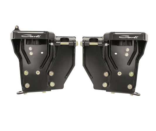 A pair of black metal brackets adorned with multiple bolts and prominently displaying the "Carli Suspension" brand name, these Fabricated Coil Buckets are specifically designed for 08-16 Ford F-250/F-350 (4WD) trucks. Positioned symmetrically against a white background, they are perfect for automotive enthusiasts seeking precision.