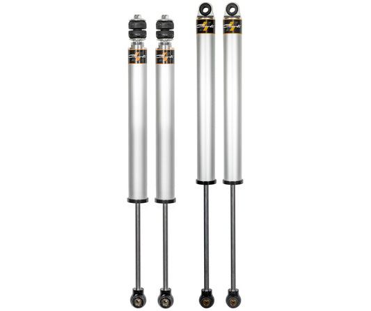 Four silver automotive shock absorbers featuring black and gold accents are arranged vertically against a white background, evoking the high-performance Carli Suspension 13-23 Ram 3500 Diesel Carli-Spec 2.0" IFP 2.5" Lift Shock Set.