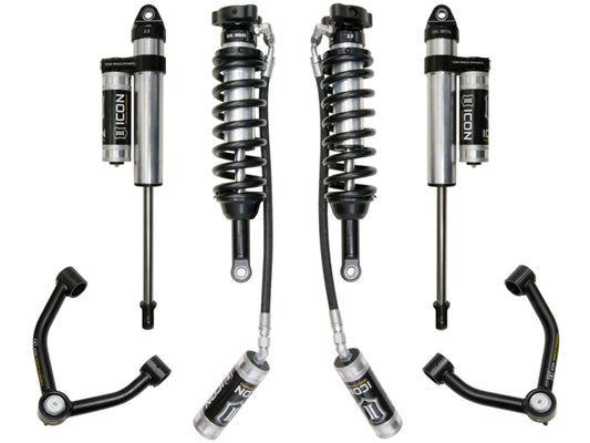 The image showcases the ICON 2015+ Chevrolet Colorado 1.75-3in Stage 4 Suspension System, a product by ICON. The setup includes four shock absorbers with coil springs attached, two upper control arms, and two extra link components, all featuring an advanced Delta Joint design. These parts are symmetrically displayed against a white backdrop.