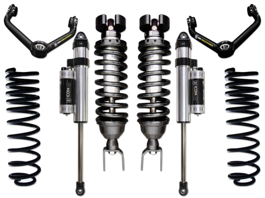 The ICON 09-18 Ram 1500 4WD .75-2.5in Stage 5 Suspension System by ICON showcases an assortment of components, including two coilover shocks, two shock absorbers, two coil springs, and two control arms, all elegantly displayed on a pristine white background in perfect symmetry.