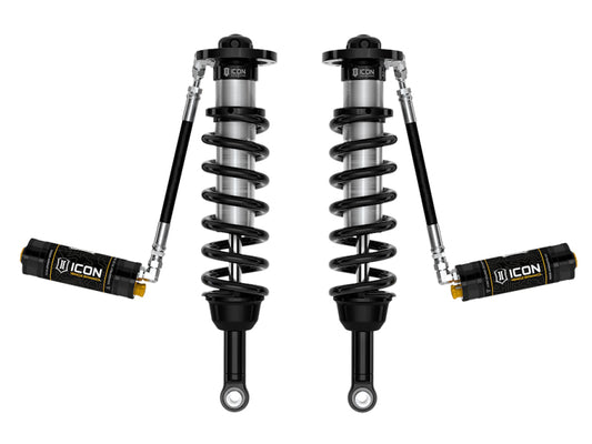 The ICON 2022+ Toyota Tundra 2.5 Series VS RR CDCV Coilover Kit features a pair of black and silver coilover shocks with attached reservoirs, meticulously designed for off-road suspension in Toyota Tundras. The 'ICON' brand is prominently displayed on both components, highlighting coiled springs and cylindrical reservoirs against a pristine white background.