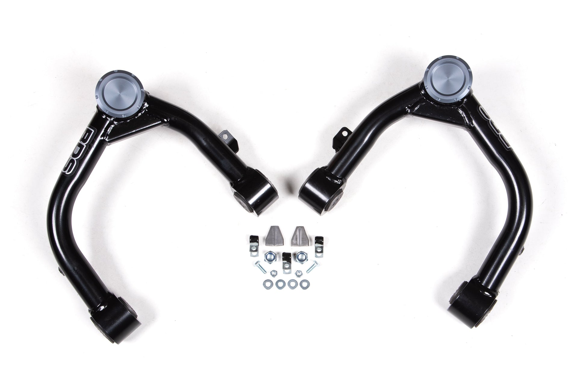 A set of black Upper Control Arms from BDS, complete with ball joints and bushings, designed for a 6-inch lift on Chevy Silverado and GMC Sierra 1500 (2019-2023) models with Adaptive Ride Quality, are displayed on a white background. Accompanying the control arms is an assortment of installation hardware including bolts, nuts, and washers. Perfect for enhancing the suspension system of your GMC Sierra or upgrading your Chevy Silverado.