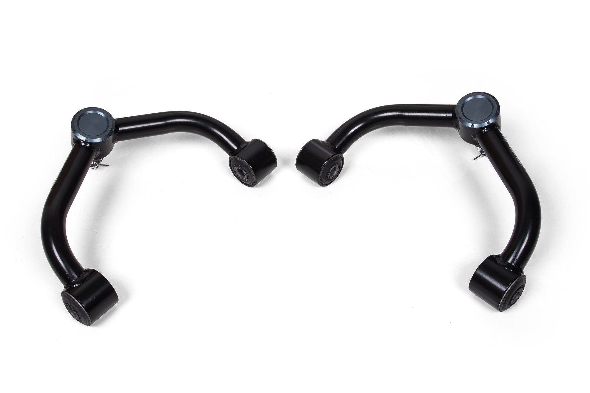 Two black, curved metal upper control arms with bushings on each end, likely components for an automotive suspension system, are displayed side by side against a plain white background. Crafted from high-strength steel tubing, these BDS Upper Control Arm Kits for Chevy Silverado and GMC Sierra 2500HD / 3500HD (20-24) promise durability and precision.