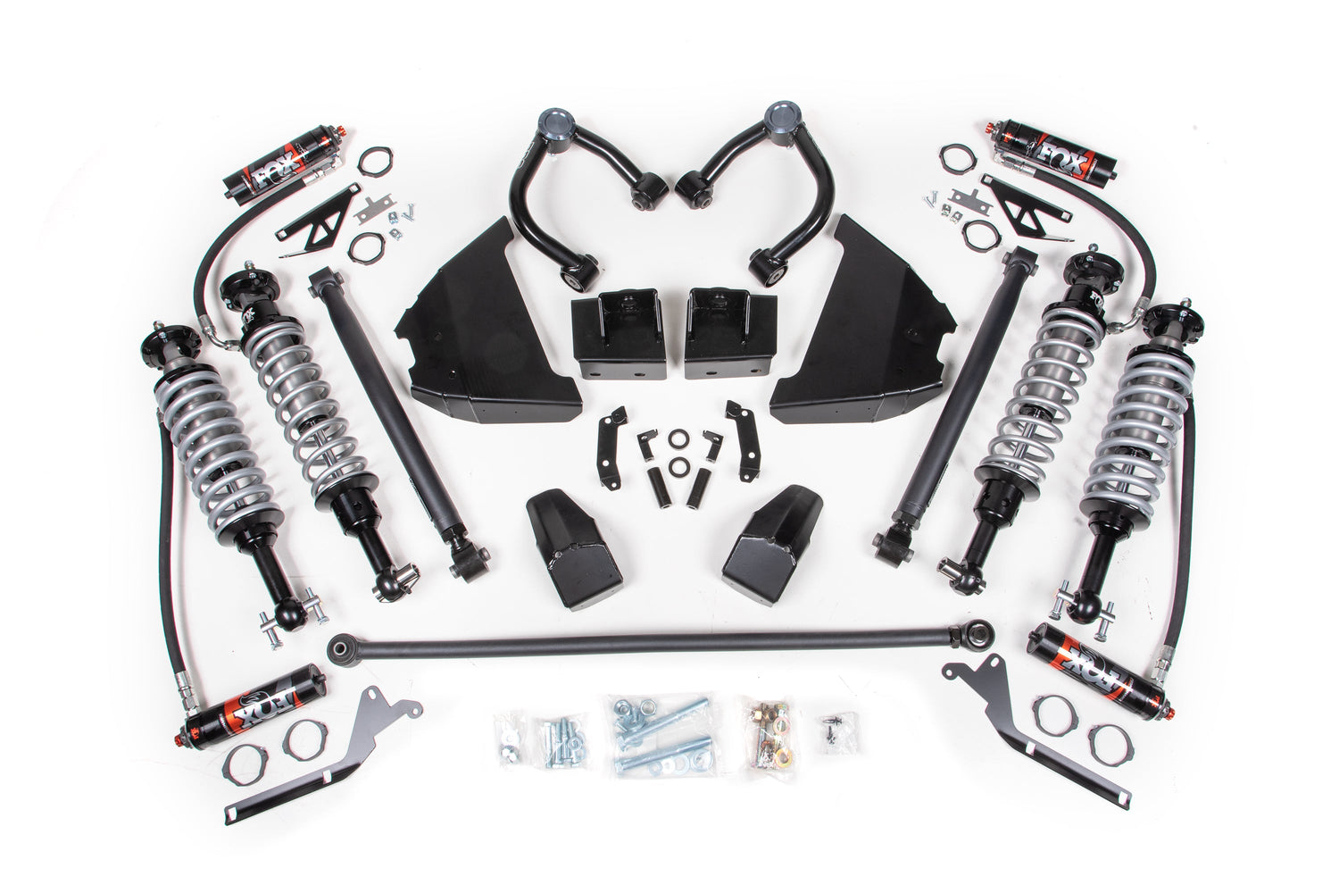 A neatly arranged 4 Inch Lift Suspension Package - KOH Edition by BDS, featuring FOX 2.5 Performance Elite coil-over shocks, springs, upper control arms, and various mounting hardware components displayed on a white background. This suspension kit for the Ford Bronco (21-23) includes coilovers, spacers, bolts, brackets, and bushings.