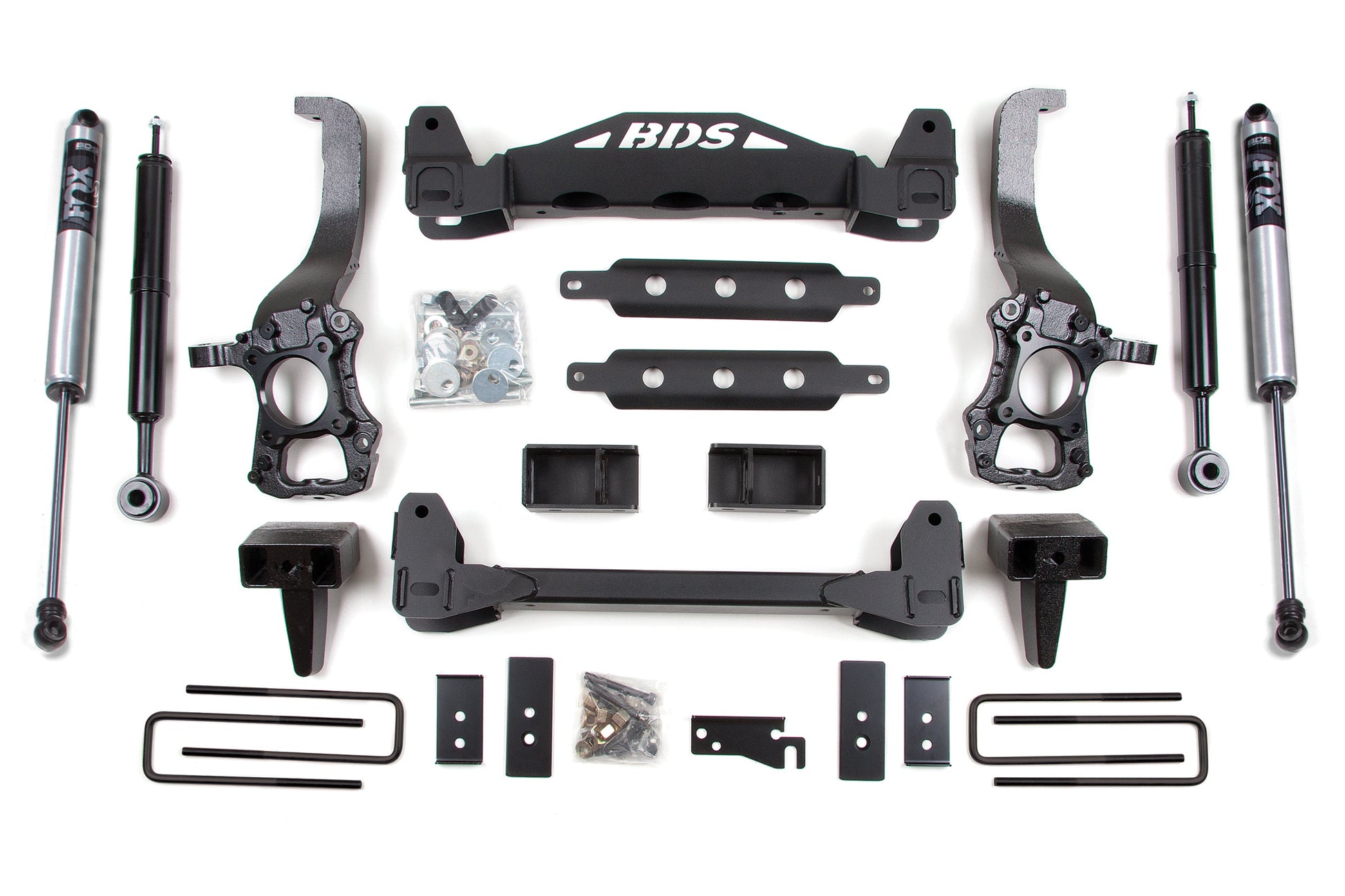 Image of the BDS 6 Inch Lift Kit for Ford F150 (15-20) 2WD, showcasing two shock absorbers, various brackets, control arms, U-bolts, and other hardware components. All items are arranged neatly and symmetrically on a white background. Ideal for off-road protection.