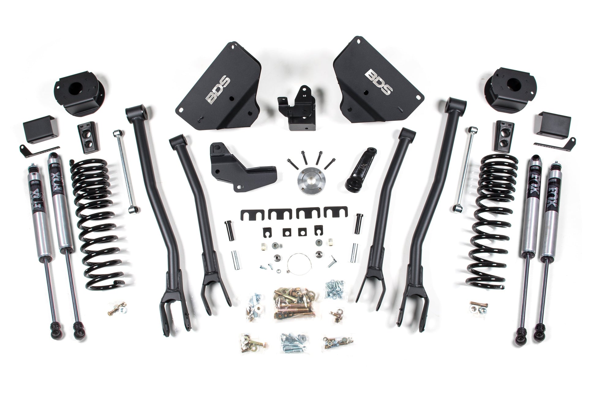 A neatly arranged display of various automotive suspension components, including Pro-Ride coil springs, shock absorbers, control arms, brackets, and assorted hardware. The parts appear to be for a 4 Inch Lift Kit with a 4-Link conversion for the RAM 2500 with Rear Air Ride (2014-2018) 4WD Gas model, all labeled with the brand "BDS.