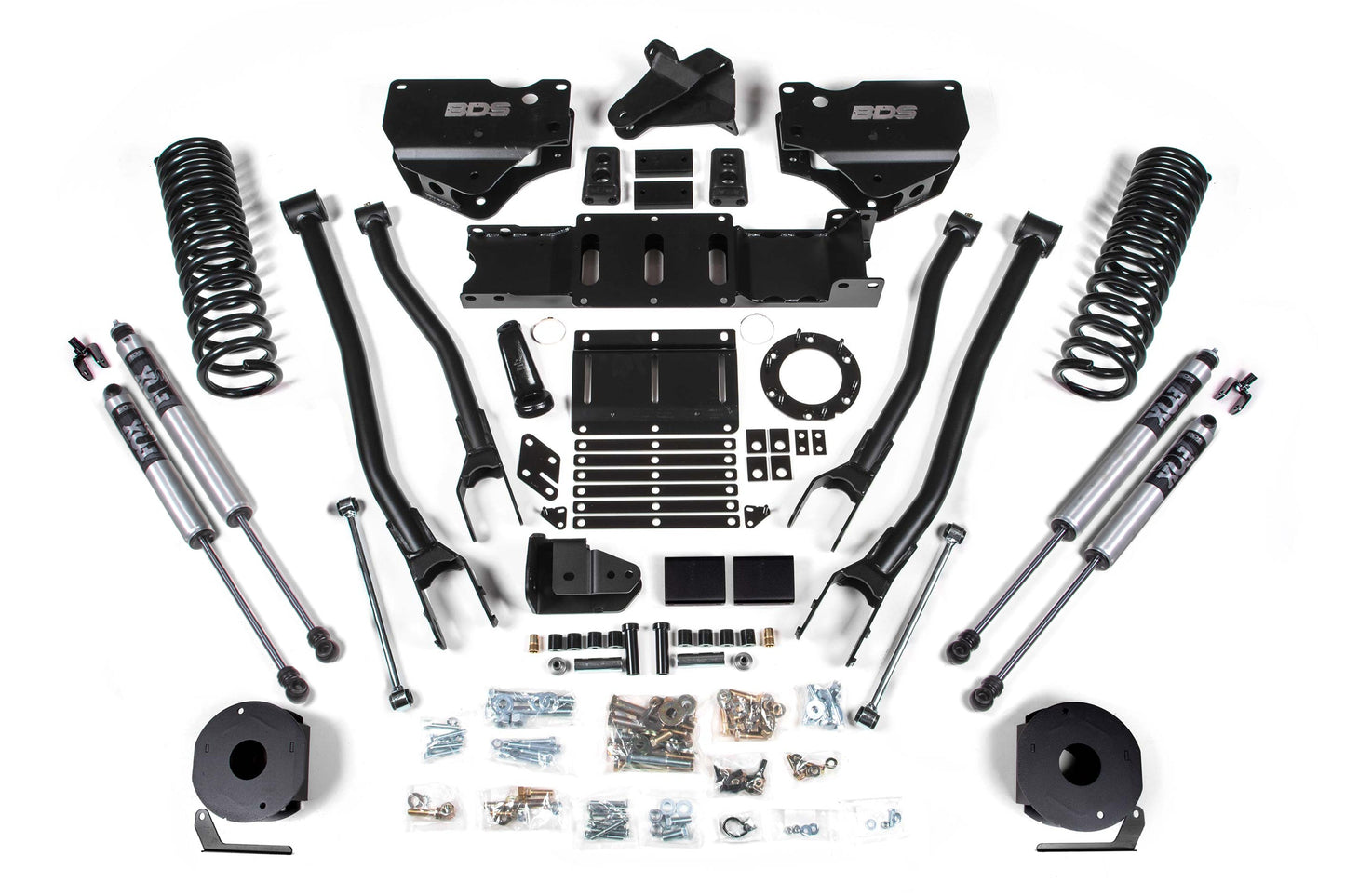 The BDS 6 Inch Lift Kit with 4-Link for a RAM 2500 Diesel (2019-2024) - 4WD with Rear Air Ride is laid out on a white background. The kit includes coil springs, shock absorbers, control arms, brackets, mounting hardware, and various metal parts and fasteners, all organized in a symmetrical arrangement.