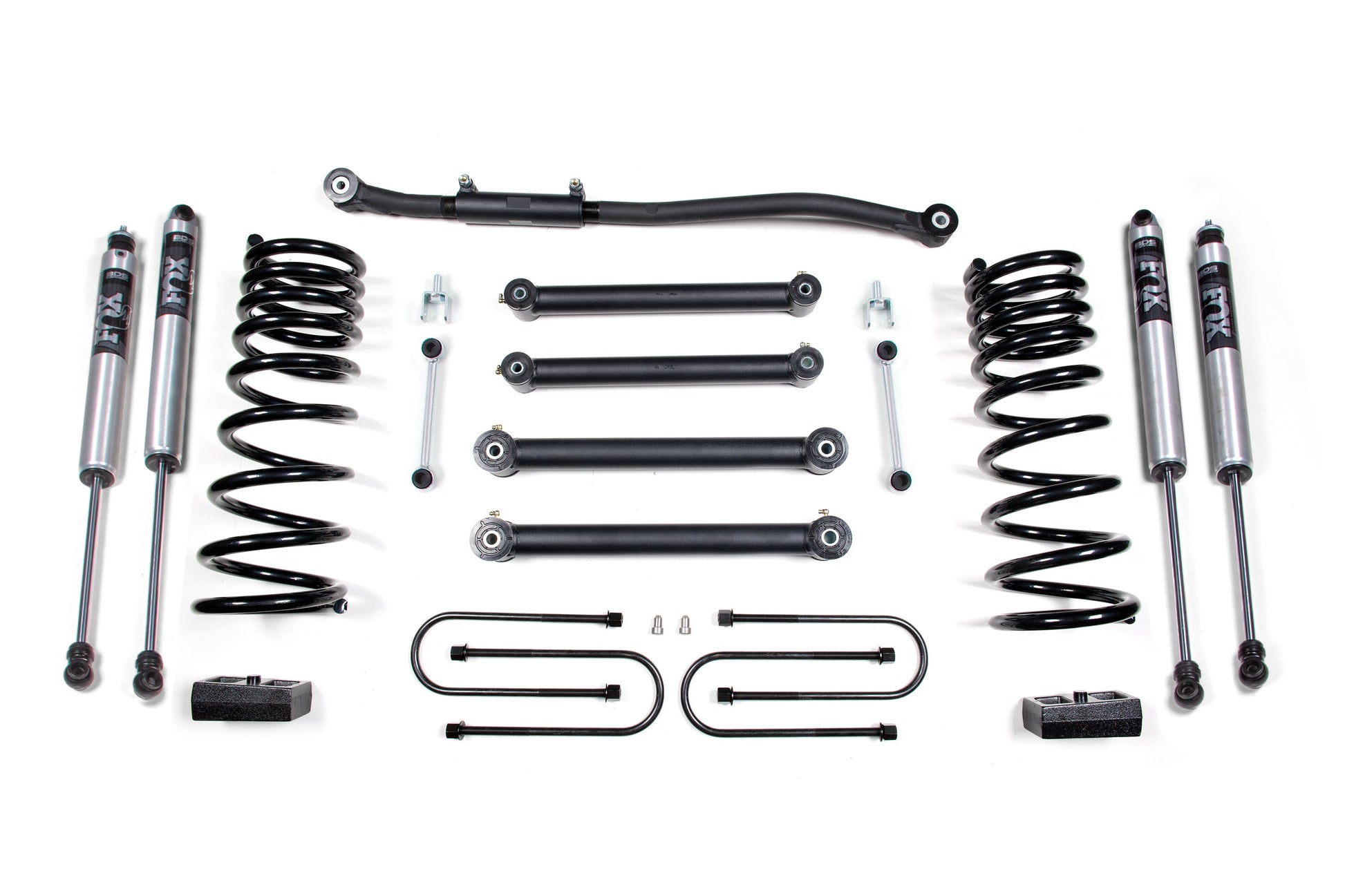 A flat lay of various automotive suspension parts, including four shock absorbers, two coil springs, multiple control arms, brackets, spacers, and hardware. The components from the BDS 3 Inch Lift Kit for Dodge Ram 2500 (03-13) & 3500 (03-12) 4WD Diesel are arranged symmetrically and neatly against a white background.