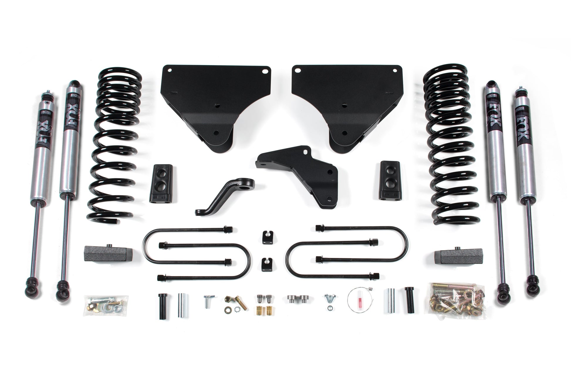 A comprehensive set of vehicle suspension components laid out on a white background, including FOX shock absorbers, Pro-Ride coil springs, brackets, and various hardware like bolts and clips. The setup is perfect for the 4 Inch Lift Kit by BDS designed for the 2013-2018 RAM 3500 Diesel 4WD.