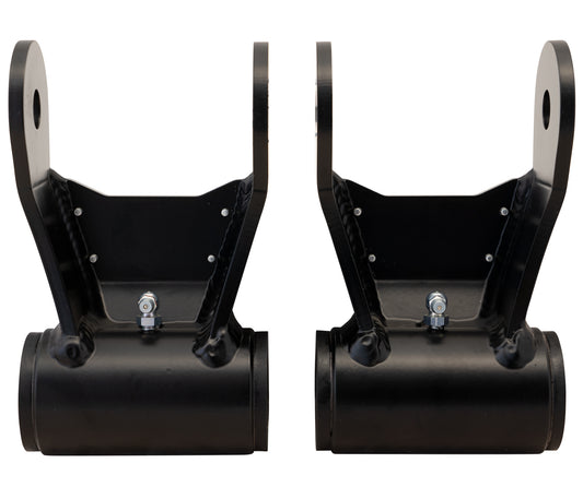 Displayed against a white background are two black metal shackle brackets, each with cylindrical bases and bolt attachments. They feature holes at the top for mounting and are ideal for a 4x4 leaf spring upgrade. These brackets are part of the Carli Suspension 05-23 Ford F-250/F-350 (4WD) Fabricated Leaf Spring Shackle set.