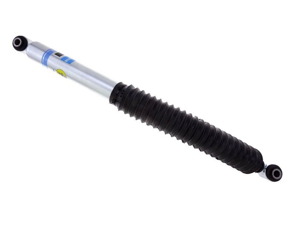 The Bilstein Shocks B8 5100 Series 19-24 GM 1500 Rear Shock Absorber in silver, equipped with a black rubber boot, is perfect for lifted trucks and SUVs. This shock absorber includes bushings on both ends to ensure reliable mounting.