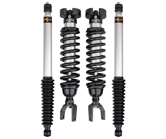 A set of four automotive shock absorbers is available, featuring the Carli Suspension 19-23 Ram 1500 (4WD) 2.5" Lift Carli Spec Coilover Set. This includes two coilovers with black springs providing a 2.5" lift and two standard shocks, all with a metallic finish.