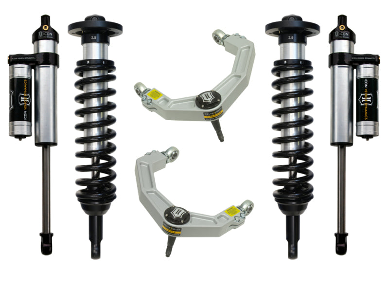 A depiction of the ICON 04-08 Ford F-150 4WD 0-2.63in Stage 3 Suspension System featuring four shock absorbers with springs and two billet upper control arms from ICON. The components are meticulously arranged on a plain background, emphasizing their corrosion resistance and highlighting the sophisticated design features of the Delta Joint.