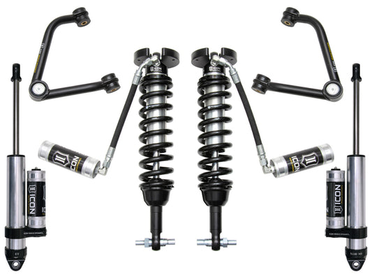 Image of automotive suspension components showcasing two coilover shocks, shock absorbers with reservoirs, and control arms. Arranged symmetrically on a white background, the display highlights ICON's patented Delta Joint for superior performance and the tubular steel upper control arms included in the ICON 2019+ GM 1500 1.5-3.5in Stage 3 Suspension System w/Tubular Uca for enhanced durability.