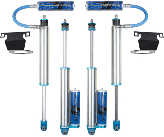 A set of four Pintop 2.5 leveling shock absorbers with attached reservoirs, designed for off-road Dodge Ram vehicles with a 3.25" lift, is showcased against a pristine white background. The Carli Suspension components are intended for the 14-23 Ram 2500 (4WD - Coil/Air) DIESEL models and come with mounting accessories in a sleek silver and blue design.