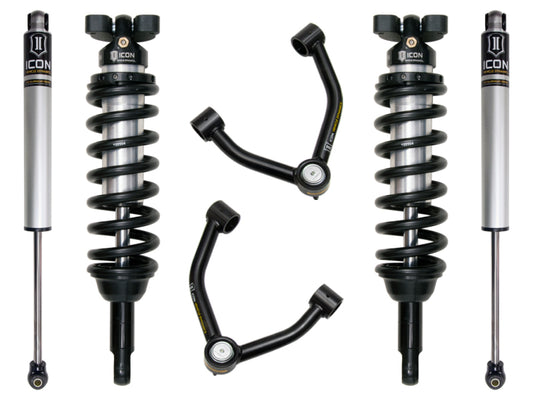 An image displaying the ICON 2015+ Chevrolet Colorado 1.75-3in Stage 2 Suspension System, featuring two coilover shock absorbers with black springs and silver bodies, along with two upper control arms equipped with Delta Joint high-angle ball joints from ICON. The components are neatly arranged against a white background.