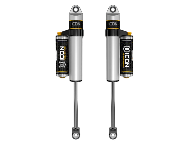 Shown are two ICON 07-18 GM 1500 0-1.5in Rear 2.5 Series Shocks VS PB CDCV - Pair, featuring remote reservoirs. These shocks, from the reputable brand ICON, boast a sleek silver design with distinctive black and yellow accents and prominently display the ICON logo on both the reservoirs and main bodies. Their robust construction suggests exceptional off-road performance for an impressively smooth ride.