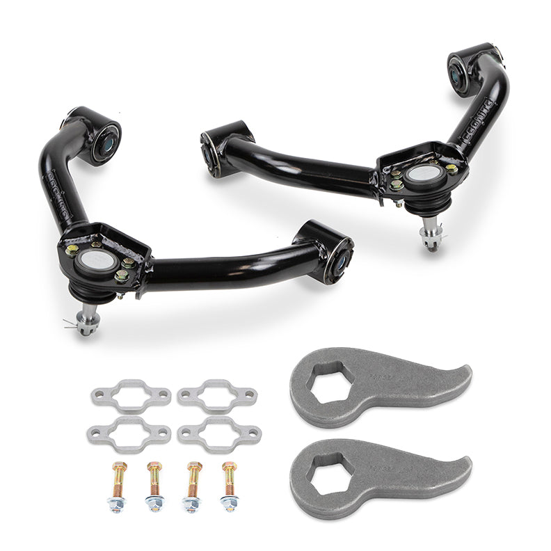 A neatly arranged set of the Cognito Motorsports 3-Inch Standard Leveling Kit for the 20-24 Silverado/Sierra 2500/3500 2WD/4WD, featuring two black upper control arms, four silver nuts and bolts with accompanying washers, and two silver torsion bar keys, all displayed on a white background.