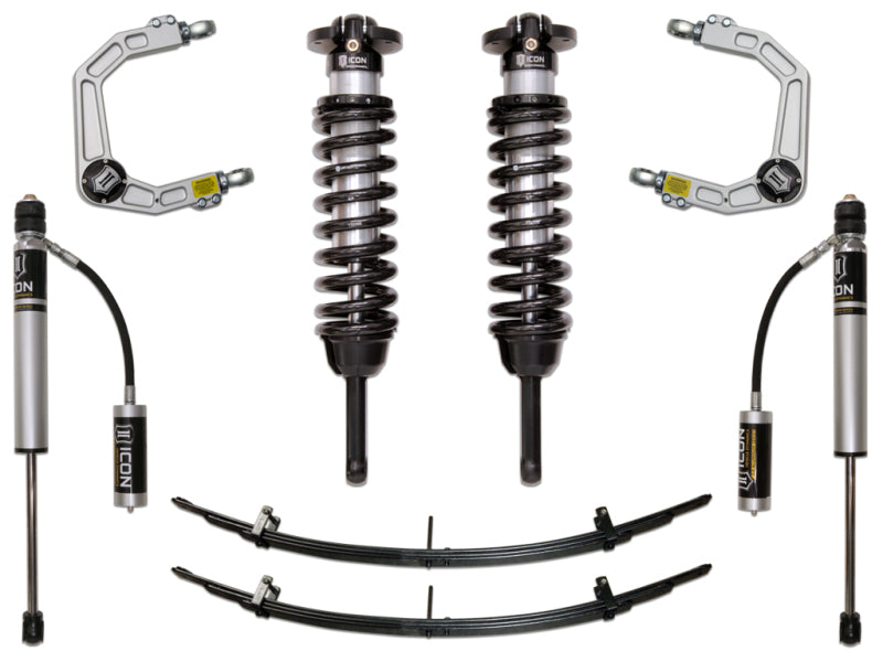 The image depicts the ICON 05-15 Toyota Tacoma 0-3.5in/2016+ Toyota Tacoma 0-2.75in Stg 3 Suspension System w/Billet Uca by ICON, showcasing corrosion-resistant components. The kit includes two coilover shocks with coil springs, two upper control arms with Delta Joints, two rear shock absorbers with remote reservoirs, and two leaf springs. These components are arranged symmetrically on a white background.