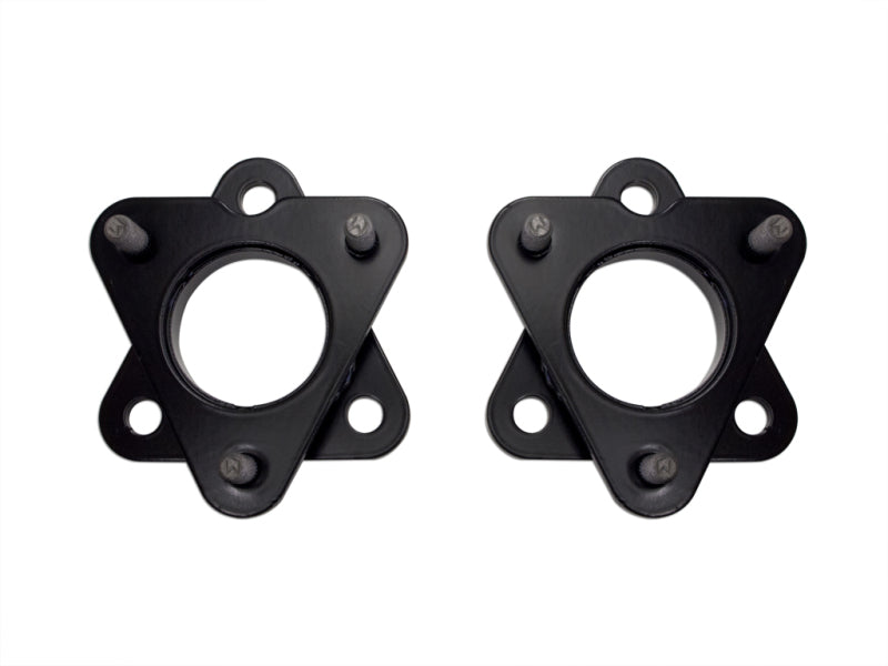 An image of two black, triangular metal brackets with circular openings in the center, each featuring three evenly spaced protruding bolts around the edge. Designed for mounting or suspension purposes, these brackets are ideal for an ICON 06-13 Dodge Ram 1500 2in Spacer Kit. The background is plain white.