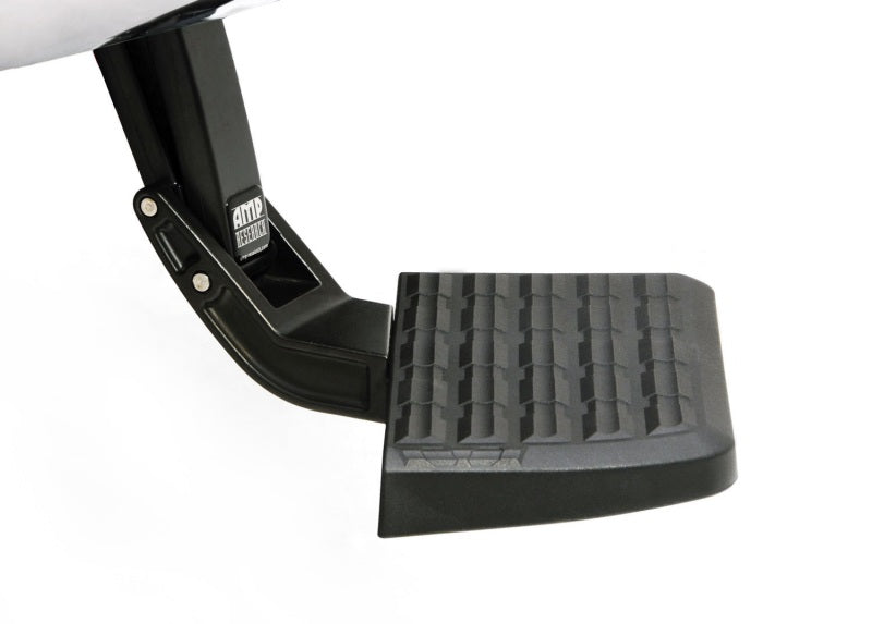 Here is a close-up of the AMP Research 2015-2017 GMC Sierra 2500/3500 BedStep in black, showcasing its textured black stepping surface and sturdy metal mounting bracket, both labeled with the "AMP Research" logo. This robust design features the retractable BedStep(TM) to provide easier access to your truck bed or cab.