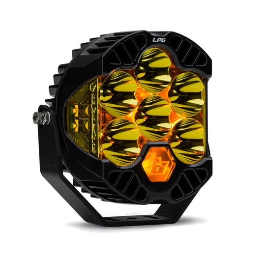 The Baja Designs LP6 Pro Spot LED - Amber is a round LED light with a hexagonal pattern of six amber LEDs and black housing. "LP6 Pro" is marked on top, and it includes a bottom-mounted bracket.