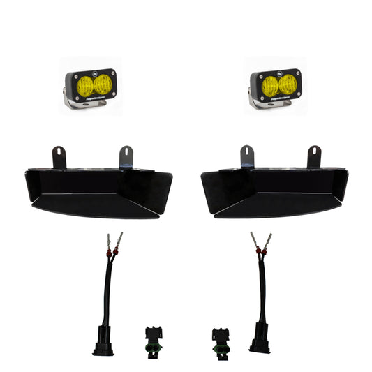 Image of the Baja Designs 2019+ Ram 2500/3500 S2 Wide Cornering Fog kit - Amber, showcasing off-road amber LED pod lights and fog light brackets. This kit by Baja Designs includes two amber LED pods, two black metal brackets, wiring harnesses, and connectors. Components are arranged separately against a white background.