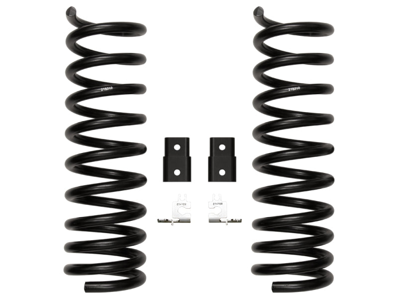 Two black coil springs are vertically aligned on a white background. Between the springs are two black mounting brackets and two small metal clips, each with a distinct shape and structure. This setup is part of the ICON 2014+ Ram 2500 2.5in Front Dual Rate Spring Kit from ICON.