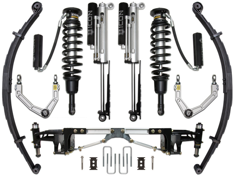 The ICON 2017+ Ford Raptor Stage 4 Suspension System by ICON features a comprehensive collection of automotive suspension components, including coilover shocks, leaf springs, control arms, and a rear bump stop kit designed for enhanced energy absorption. Additionally, various mounting hardware is included. The components are symmetrically arranged on a white background.