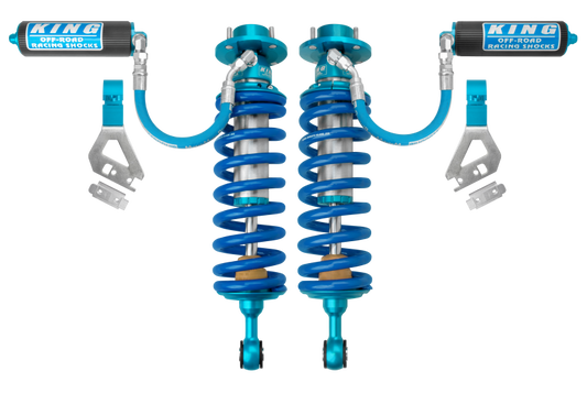 Image of two blue King Shocks 2022+ Toyota Tundra 2.5 Dia. Front Remote Reservoir Coilover shocks with coiled springs and attached hoses, engineered to enhance ride quality. Placed side by side, the brand "King Shocks" is visible on each, ideal for a Toyota performance kit seeking an optimal damping curve.