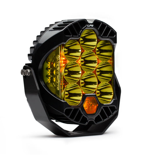 The Baja Designs LP9 Racer Edition Series High Speed Spot Pattern LED Light Pods - Amber is a hexagonal off-road LED light pod with nine amber lenses. Featuring a rugged black casing, "LP9" adorns the top, showcasing its robust structure and high-speed spot pattern capabilities.