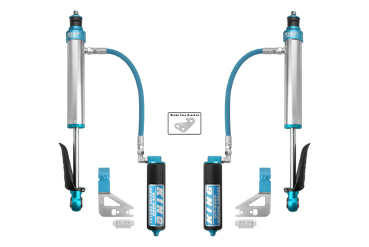 A pair of King Shocks 2022+ Toyota Tundra 2.5 Dia. Rear Remote Reservoir Shocks, featuring a performance kit in blue and silver. Specifically designed for TOYOTA, these components include remote reservoirs and brackets with symmetrically arranged connecting hoses, enhancing off-road ride quality. Ideal for those seeking top-tier performance parts from King Shocks.