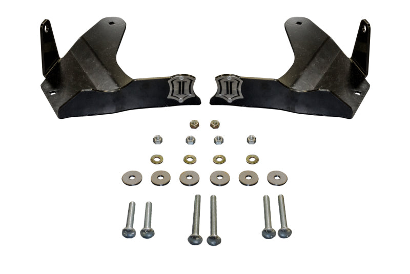 Two black metal brackets are positioned side by side, facing each other, accompanied by an assortment of screws, nuts, and washers neatly arranged below them. These components seem to be part of the ICON 07-09 Toyota FJ / 03-09 Toyota 4Runner / 05-15 Toyota Tacoma LCA Skid Plate Kit from ICON, designed to protect lower control arms for optimal off-road performance.