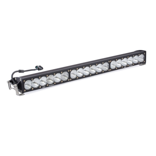 The Baja Designs OnX6 Series Driving Combo Pattern 30in LED Light Bar is crafted for vehicle use, showcasing multiple circular bulbs aligned in a single row with a connector cable positioned on one end. It features mounting brackets on both sides and is elegantly displayed against a white background.