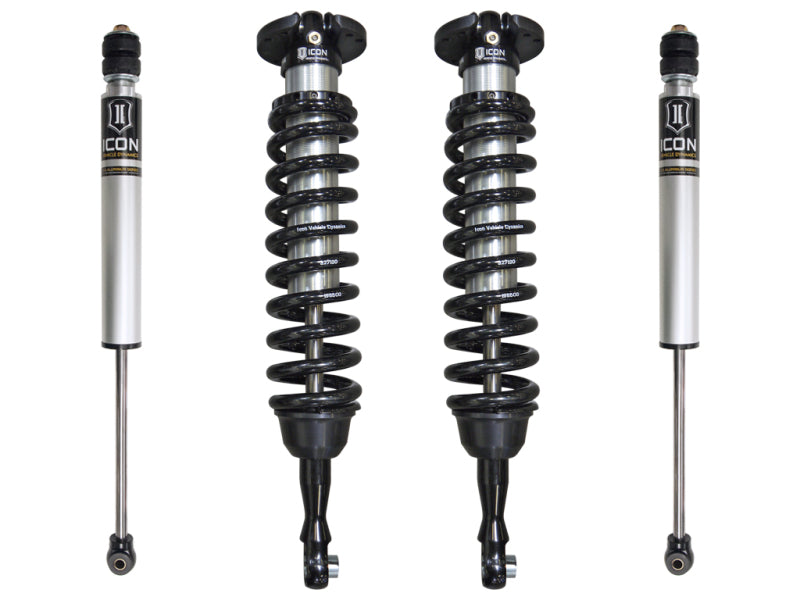 Four ICON coilover shocks from the 2007+ Toyota Tundra 1-3in Stage 1 Suspension System are arranged vertically. The two in the center have coil springs, while the ones on the sides do not. Each shock features a silver body with black components and prominently displays the ICON logo and label. This setup is perfect for upgrading your Toyota Tundra suspension.