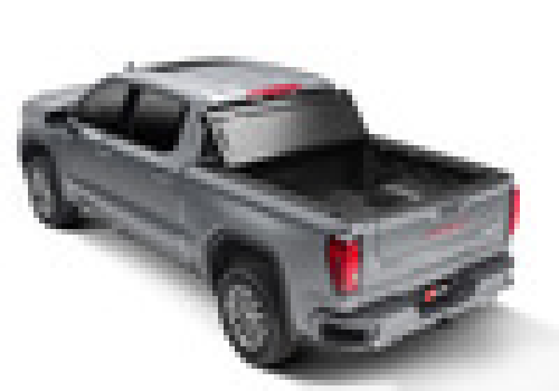 A pixelated image of a gray Chevy Silverado 1500 with a 6ft 6in bed (New Body Style) from the years 2019-2020, viewed from the rear left side. The truck is equipped with a BAK BAKFlip F1 hard folding bed cover made of Fiberglass Reinforced Polymer. The tail lights and rear bumper are prominently visible, though the details are obscured due to the pixelation.