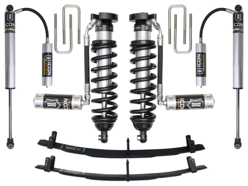 Image showing a complete ICON 95.5-04 Toyota Tacoma 0-3in Stage 3 Suspension System, including two coilover shocks with reservoirs, two additional shock absorbers, and two leaf springs. Items are arranged symmetrically with the ICON logo visible on components.