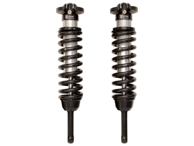 Image of two black ICON 07-09 Toyota FJ / 03-09 Toyota 4Runner 2.5 Series VS IR Coilover Kit shocks with coiled springs, placed side by side vertically on a white background. Each rebuildable and revalveable shock absorber has a cylindrical body and adjustable mounts at both ends, designed for superior off-road performance.